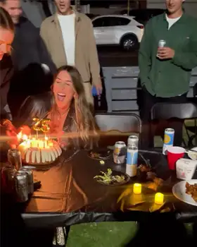 Guests celebrating a birthday at a backyard hibachi party with a private chef cooking live.