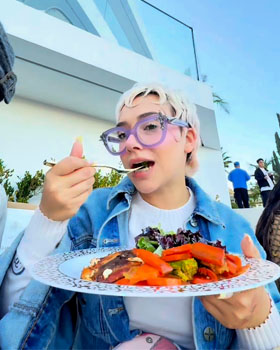 Dozens of social media influencers enjoying a live hibachi party with chef performances, flames, and freshly cooked food